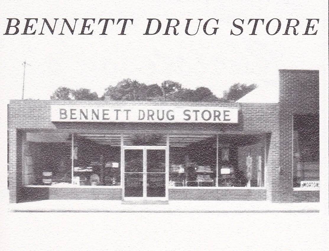Historic black-and-white photo of Bennett Drug Store in downtown Harrison, showing the storefront with large display windows and the Bennett Drug Store sign above the entrance.
