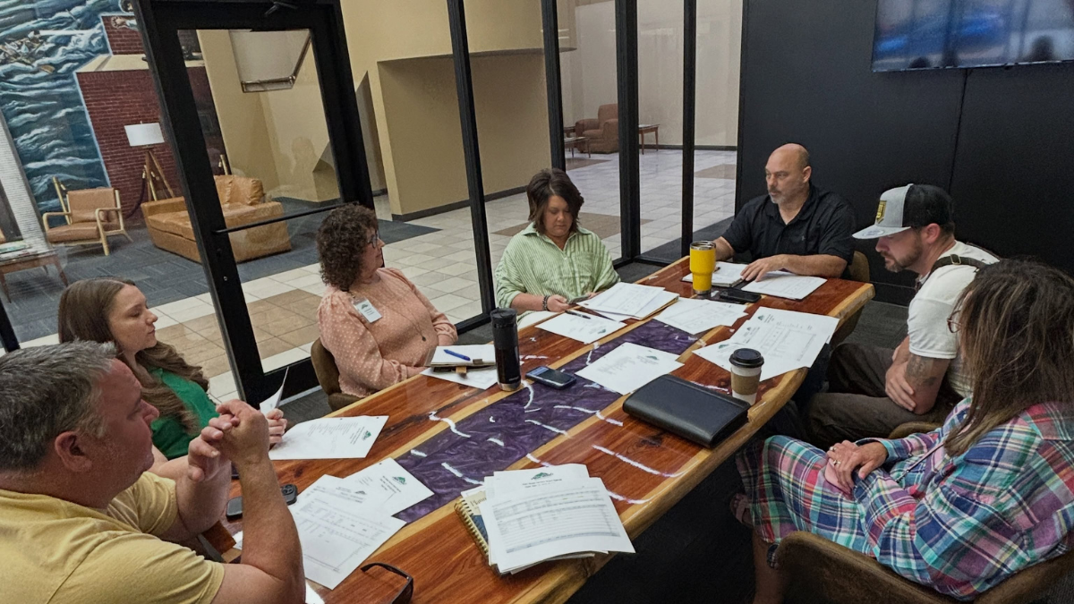Main Street Harrison board members gathered around a table during a working meeting inside Rush Plaza in downtown Harrison.