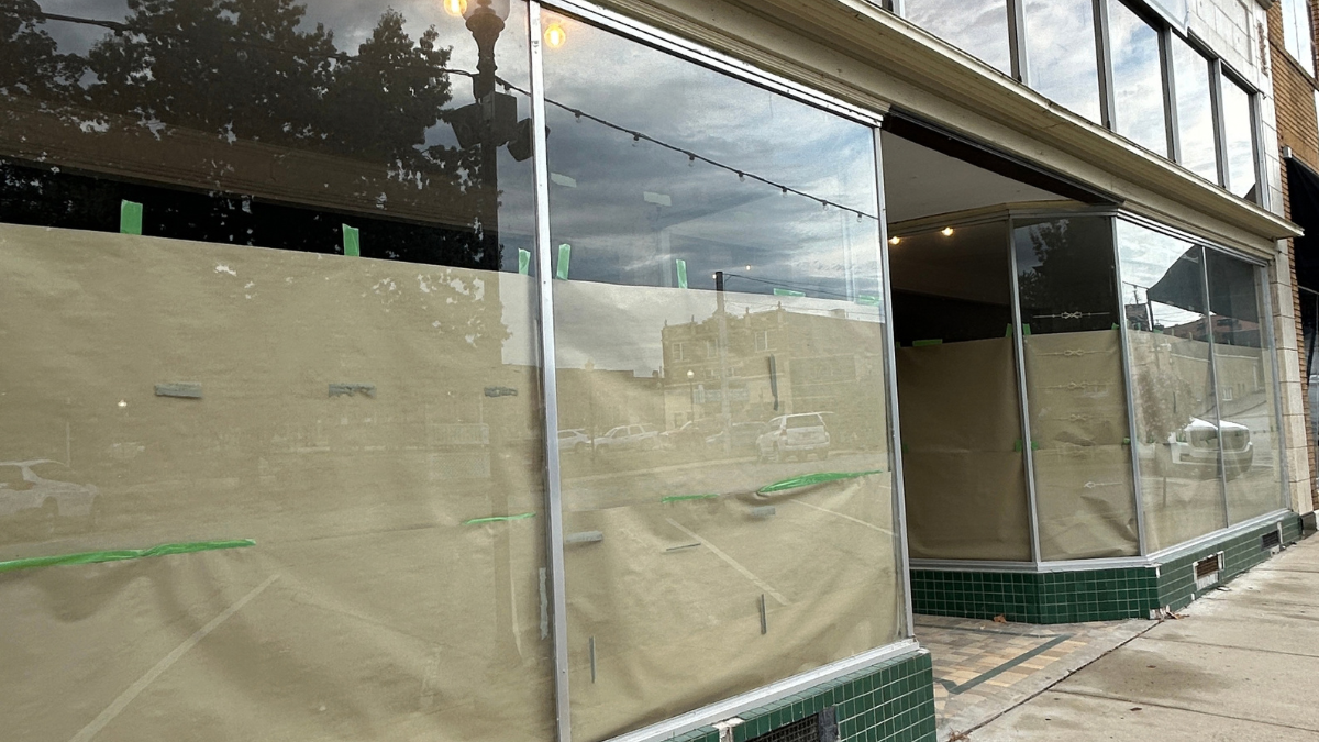 Paper-covered storefront windows on a historic building in downtown Harrison during renovation.