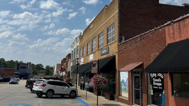 Historic commercial buildings and storefronts along a street in downtown Harrison, Arkansas, showcasing the district's historic architecture.